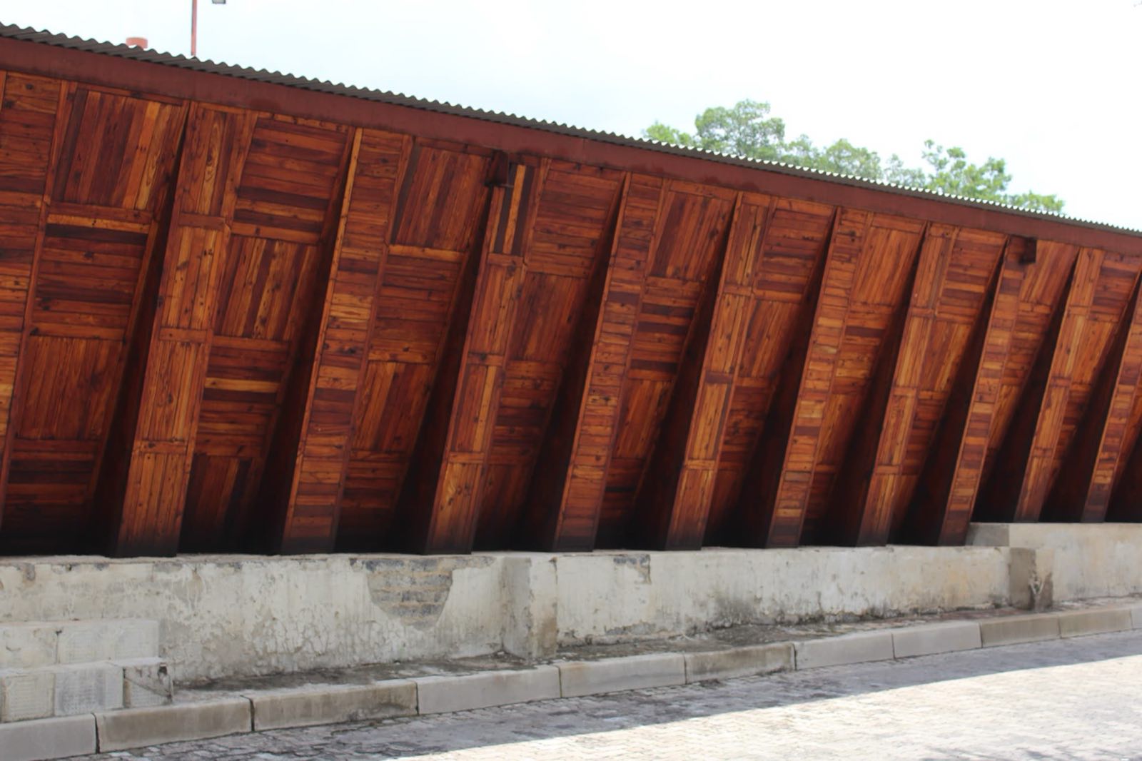 Angled pallet-timber panels on a building at Qurtuba