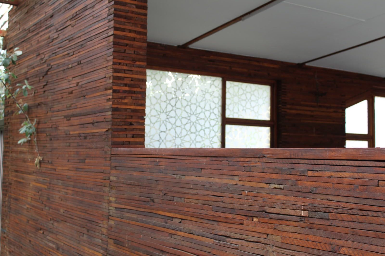A timber post and pallet-block wall in an open pavilion at Qurtuba